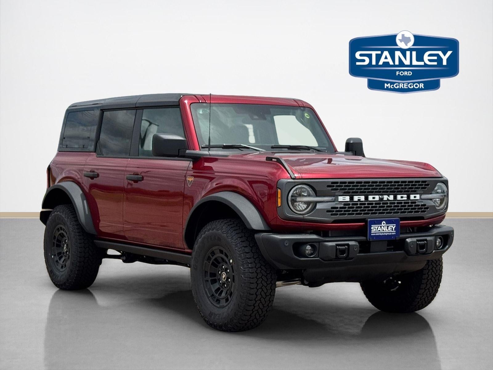 2026 Ford Bronco Badlands in Ruby Red Metallic Tinted Clearcoat — front three-quarter view