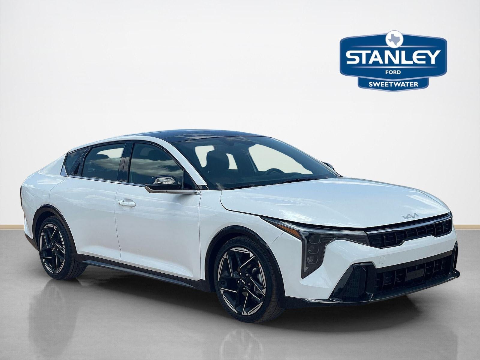 2025 Kia K4 GT-Line in Snow White Pearl — front three-quarter view